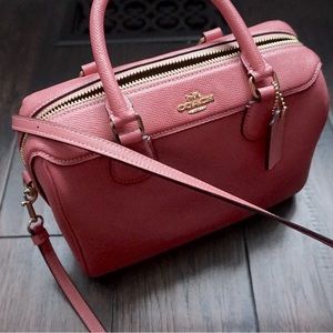 Pink small cross body coach bag .